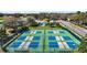 Aerial view of impeccably maintained tennis courts, a great amenity in this beautiful community at 6035 Falconbridge Pl, Mount Dora, FL 32757