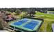 An aerial view of well-maintained tennis courts next to a golf course for active lifestyles at 6035 Falconbridge Pl, Mount Dora, FL 32757