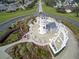 Aerial view of a lighthouse-themed gazebo area with seating, surrounded by lush landscaping and winding pathways at 6342 Sailboat Ave, Tavares, FL 32778