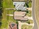 Aerial view showcasing the property layout, including landscaping, and a screened in patio at 6342 Sailboat Ave, Tavares, FL 32778