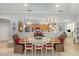 Elegant dining room adjacent to the kitchen, featuring tile flooring and modern lighting at 6342 Sailboat Ave, Tavares, FL 32778