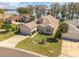 Inviting single-story home with a well-manicured lawn and an attached two-car garage near the lake at 6342 Sailboat Ave, Tavares, FL 32778