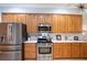 Well-lit kitchen features stainless steel appliances, marble countertops, and wooden cabinetry at 6342 Sailboat Ave, Tavares, FL 32778