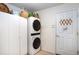 Laundry room with a stackable washer and dryer, and additional storage cabinets at 6342 Sailboat Ave, Tavares, FL 32778