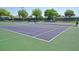 Tennis courts with green and purple colors offer a great amenity for those that want to play tennis at 6342 Sailboat Ave, Tavares, FL 32778