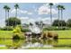 Scenic water fountain surrounded by lush landscaping, creating a tranquil and inviting community gathering space at 6342 Sailboat Ave, Tavares, FL 32778