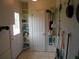 Entry from garage with storage shelving and access to outside at 713 Lillian Cir, Eustis, FL 32726