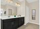 Bright bathroom featuring a double vanity with mirror, tile flooring, and a nearby shower at 9040 Azalea Sands Ln, Davenport, FL 33896