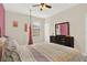 Bright bedroom features a ceiling fan, plush carpet, and a swing for a playful and cozy atmosphere at 9040 Azalea Sands Ln, Davenport, FL 33896