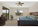 Bedroom with a walkout to a screened in porch, ceiling fan, and large window with a great view at 9040 Azalea Sands Ln, Davenport, FL 33896