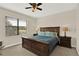 Comfortable bedroom with a ceiling fan, wooden furniture, and window overlooking the outdoors at 9040 Azalea Sands Ln, Davenport, FL 33896