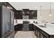 Stylish kitchen equipped with stainless steel appliances, dark cabinetry, and ample counter space at 9040 Azalea Sands Ln, Davenport, FL 33896