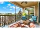 Relaxing screened-in patio with comfortable blue seating and a view of the golf course at 9040 Azalea Sands Ln, Davenport, FL 33896