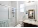 Well-lit bathroom with glass-enclosed shower, a vanity with a sink, and neutral decor at 9188 Chandler Dr, Groveland, FL 34736