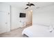 Simple bedroom featuring a ceiling fan, white walls, and a TV at 9188 Chandler Dr, Groveland, FL 34736