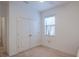 Light-filled bedroom features double doors, a window with lace curtains and neutral colored carpet at 9188 Chandler Dr, Groveland, FL 34736