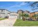 Inviting single-Gathering home with a brick driveway, stone accents, and a practical two-car garage at 9188 Chandler Dr, Groveland, FL 34736