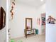 Well-lit foyer featuring a console table with decor, a mirror, and decorative wall hangings at 9188 Chandler Dr, Groveland, FL 34736