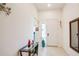 Bright foyer with tile flooring, a decorative mirror, and a console table with vibrant accents at 9188 Chandler Dr, Groveland, FL 34736