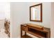 Hallway with a console table, mirror, and a view into the nearby laundry room at 9188 Chandler Dr, Groveland, FL 34736