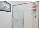 Clean and simple shower with a glass door and a built-in caddy at 9188 Chandler Dr, Groveland, FL 34736