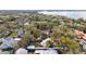 Aerial view of the property showcasing the house, detached garage, and large, tree-lined lot at 932 N Mcdonald St, Mount Dora, FL 32757