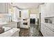 Bright and modern kitchen featuring white cabinets, stainless steel appliances, and stylish tiled flooring at 932 N Mcdonald St, Mount Dora, FL 32757