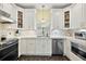 Modern kitchen with white cabinetry, stainless steel appliances, and a window over the sink at 932 N Mcdonald St, Mount Dora, FL 32757