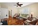 Bright living room featuring hardwood floors, comfortable seating, and classic design elements at 932 N Mcdonald St, Mount Dora, FL 32757