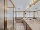 Well-lit bathroom featuring a glass-enclosed shower, double sinks, and a relaxing bathtub for a spa-like experience at 9829 Wedgewood Ln, Leesburg, FL 34788