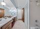 Traditional bathroom with a double vanity, a shower-tub combo, and ample storage space at 9829 Wedgewood Ln, Leesburg, FL 34788