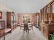 Formal dining room features classic chandelier, built in cabinets and large window at 9829 Wedgewood Ln, Leesburg, FL 34788