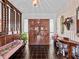 Grand foyer featuring decorative columns, tile floors, and decorative wooden double doors at 9829 Wedgewood Ln, Leesburg, FL 34788