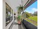 Covered porch with view to manicured yard. Hanging plant adds to the outdoor charm of this pleasant space at 9829 Wedgewood Ln, Leesburg, FL 34788