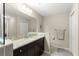 Bathroom featuring granite countertop, dark wood vanity, mirror, and tile flooring at 10420 E 161St St, Summerfield, FL 34491