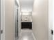 Hallway view of a bathroom with a double sink vanity and modern finishes at 10420 E 161St St, Summerfield, FL 34491