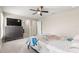 Bright bedroom with large dresser and TV and two closet doors at 10420 E 161St St, Summerfield, FL 34491