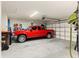 Spacious garage with red truck and ample storage at 10420 E 161St St, Summerfield, FL 34491