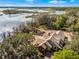 Aerial view of lakefront home with stone and brick exterior at 10944 Autumn Ln, Clermont, FL 34711