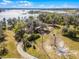 Aerial view of the property showcasing the landscape, home and lake at 10944 Autumn Ln, Clermont, FL 34711