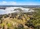 Aerial view of the property with a barn and lake access at 10944 Autumn Ln, Clermont, FL 34711