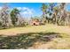 Exterior shot of the large red barn and fenced pasture area at 10944 Autumn Ln, Clermont, FL 34711