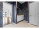 Well-lit bathroom with white cabinetry, dark blue accent wall and luxury countertops at 10944 Autumn Ln, Clermont, FL 34711