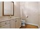 Cozy powder room with marble vanity top, decorative walls, and hardwood floors at 10944 Autumn Ln, Clermont, FL 34711