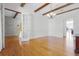 Bright dining room featuring hardwood floors, French doors, and stylish chandelier at 10944 Autumn Ln, Clermont, FL 34711