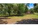 Charming exterior view of the property with wooden fence and shed at 10944 Autumn Ln, Clermont, FL 34711