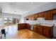 Well-appointed kitchen featuring granite countertops, wood cabinetry and hardwood floors at 10944 Autumn Ln, Clermont, FL 34711