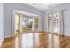 Bright living room with bay windows, hardwood floors, and natural light at 10944 Autumn Ln, Clermont, FL 34711