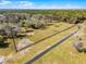 An aerial view of the long driveway and fenced property line at 10944 Autumn Ln, Clermont, FL 34711