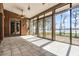 Enclosed sunroom with brick accent wall, tile floors, and lots of natural light at 10944 Autumn Ln, Clermont, FL 34711